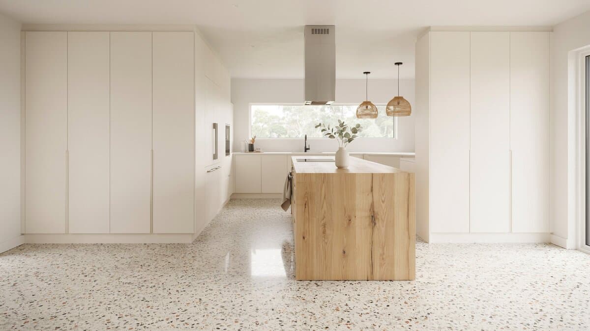 Minimalist white kitchen with wood-block island and speckled terrazzo flooring throughout