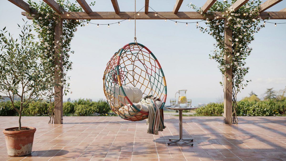 Dreamcatcher style round chair with colorful macrame under a terracotta pergola