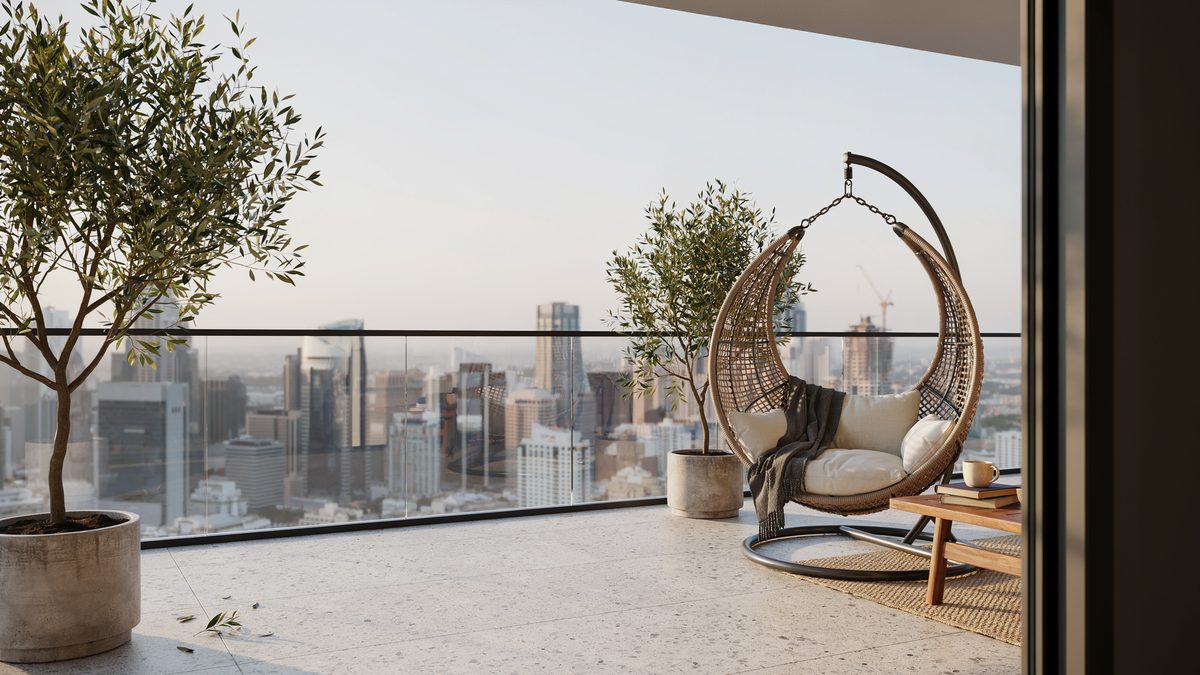 Crescent shaped rattan chair on a high balcony above a city skyline