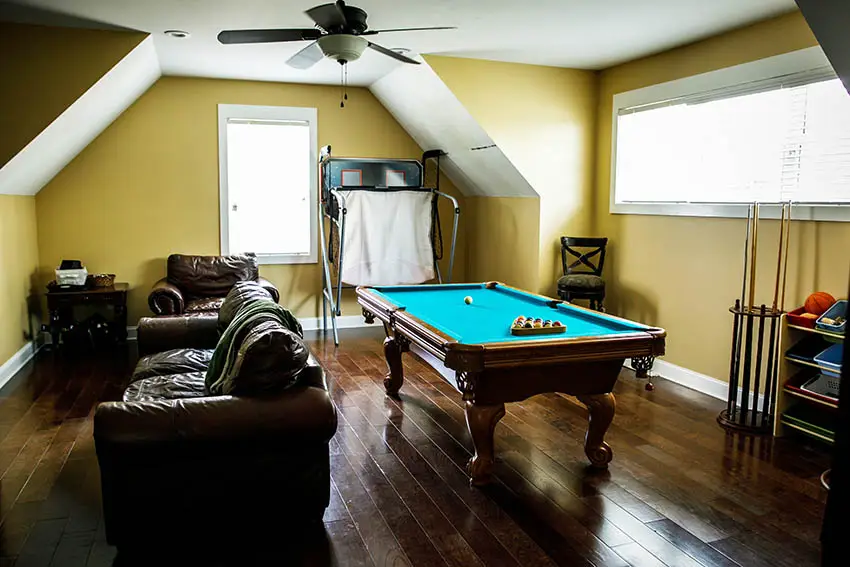 Attic man cave with hardwood floors pool table leather couches