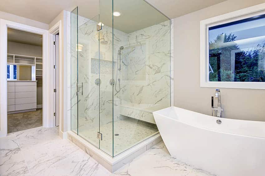 Bathroom with cultured marble shower freestanding tub and beige walls