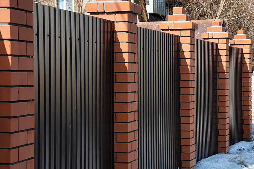 Brick and corrugated perimeter fencing