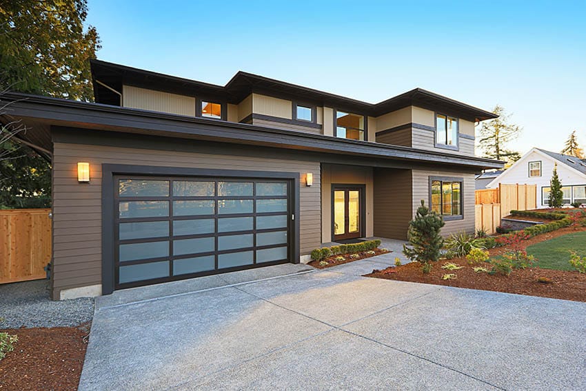 Contemporary house with exposed aggregate driveway engineered wood siding
