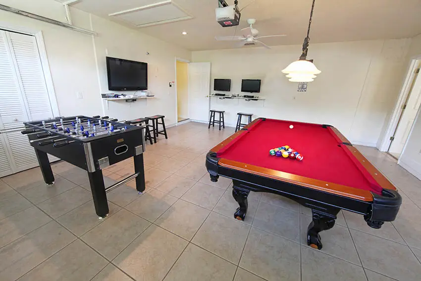 Garage man cave conversion with pool table foos ball porcelain tile floor