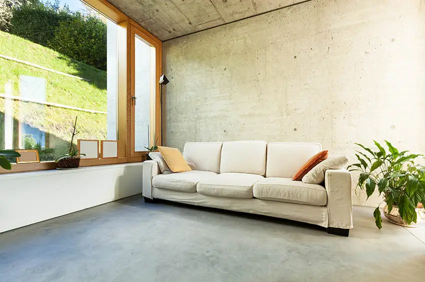 Picture windows, concrete walls and white sofa