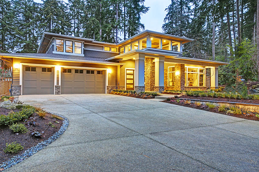House with exposed aggregate driveway three car garage