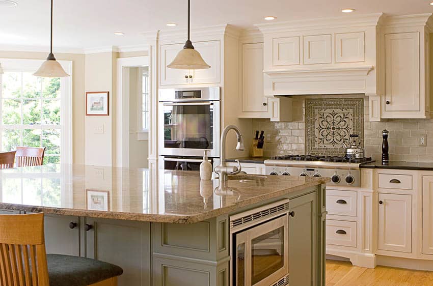 Kitchen with two tone granite countertops beige black green island white cabinets