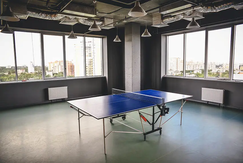 Large game room with gray epoxy floors and table tennis