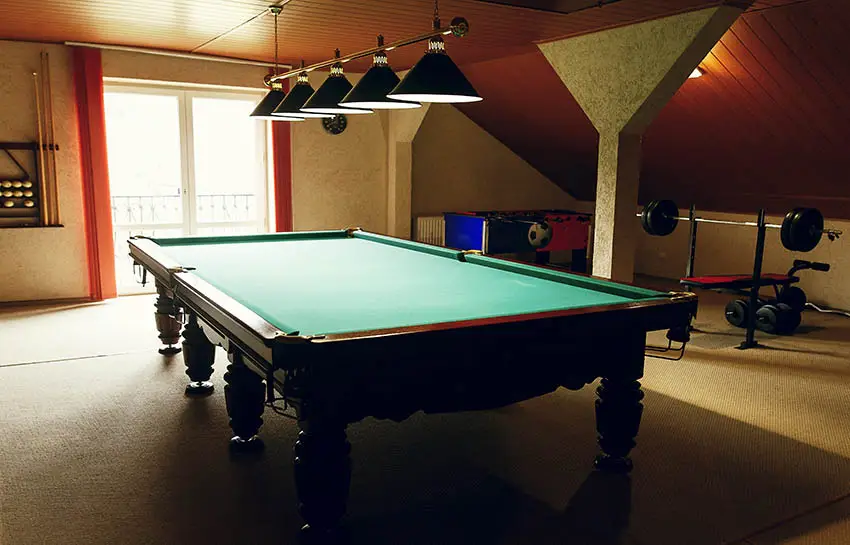 Man cave with berber carpet pool table weight bench