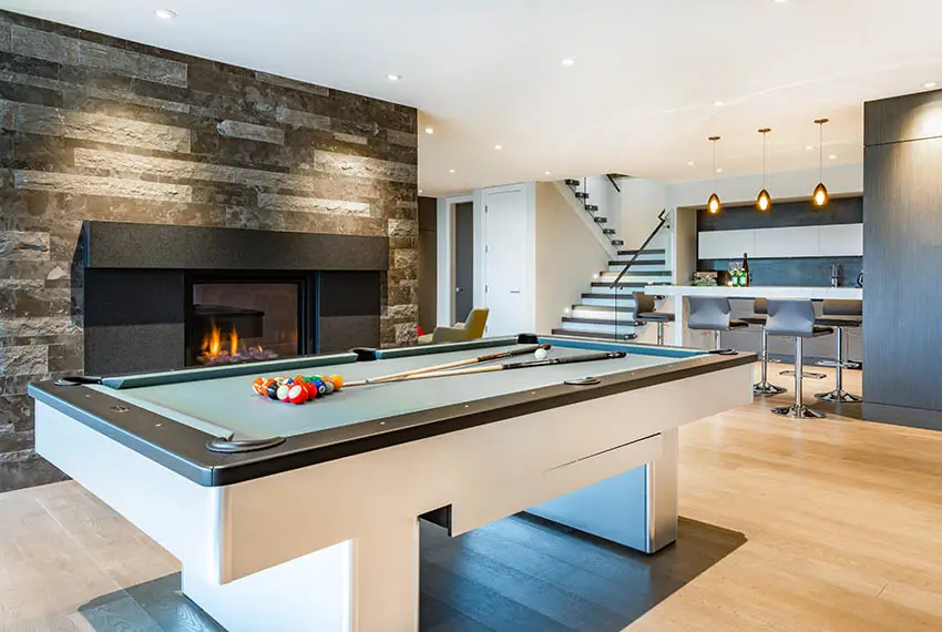 Man cave with light color laminate flooring and pool table