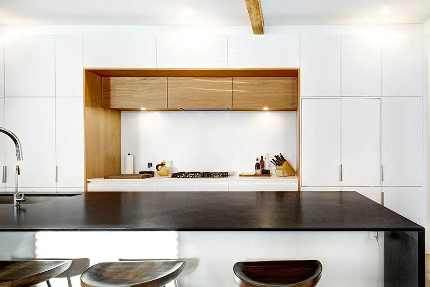 Modern kitchen with black leathered granite countertops gloss white cabinets