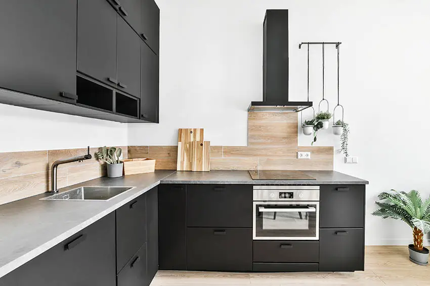 Modern kitchen with light gray laminate countertops black cabinets