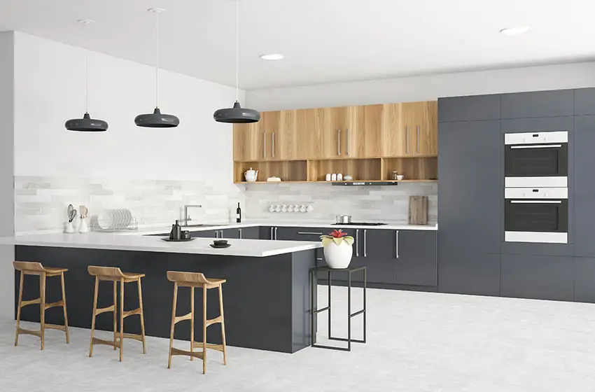 Kitchen with quartz countertop, wood cabinets and granite backsplash