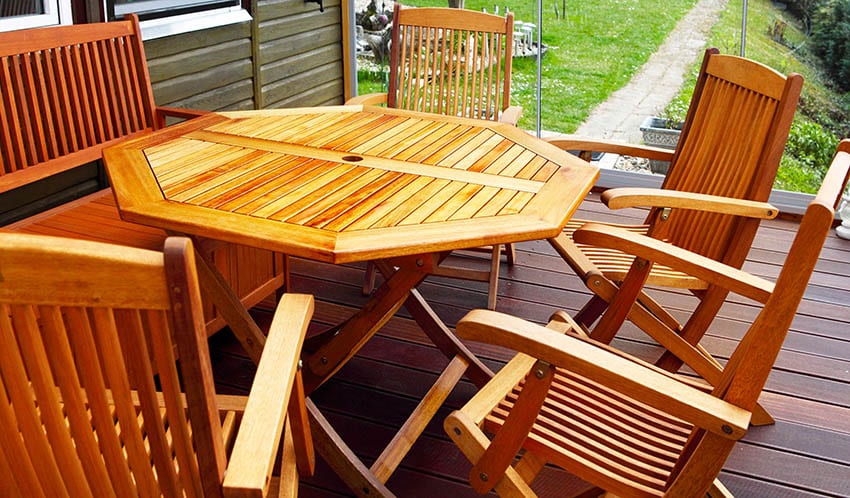 Outdoor acacia wood chairs table on deck