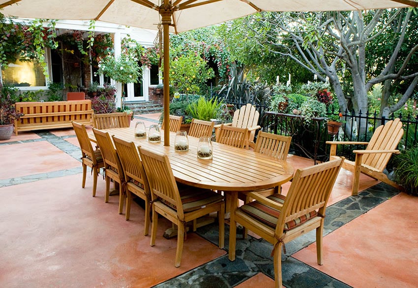 Outdoor patio with acacia wood dining table Adirondack chairs and bench