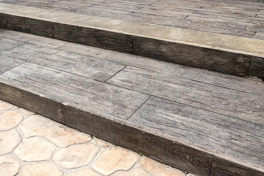 Stamped concrete wood look plank patio with steps