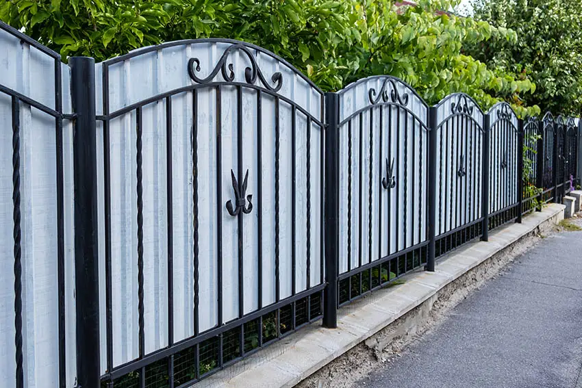 Wrought iron fence with corrugated panels