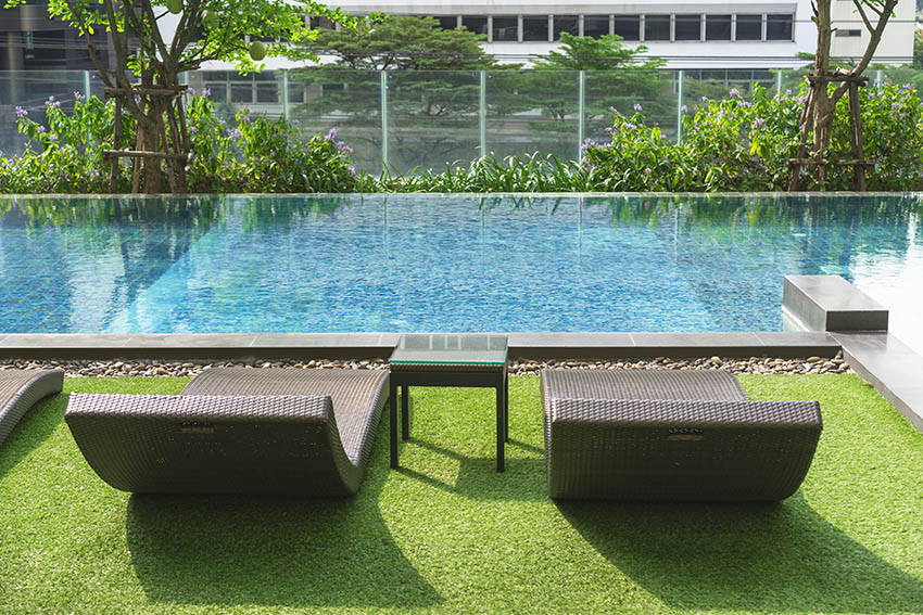 Artificial grass pool deck with lounge chairs