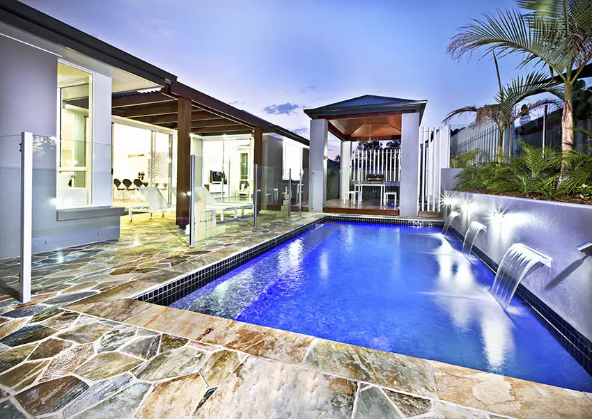 Backyard swimming pool with flagstone decking