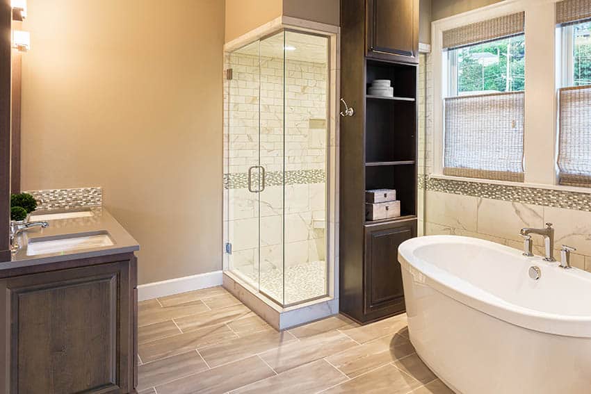 Bathroom with porcelain wood tile floors beige wall paint and light brown tile