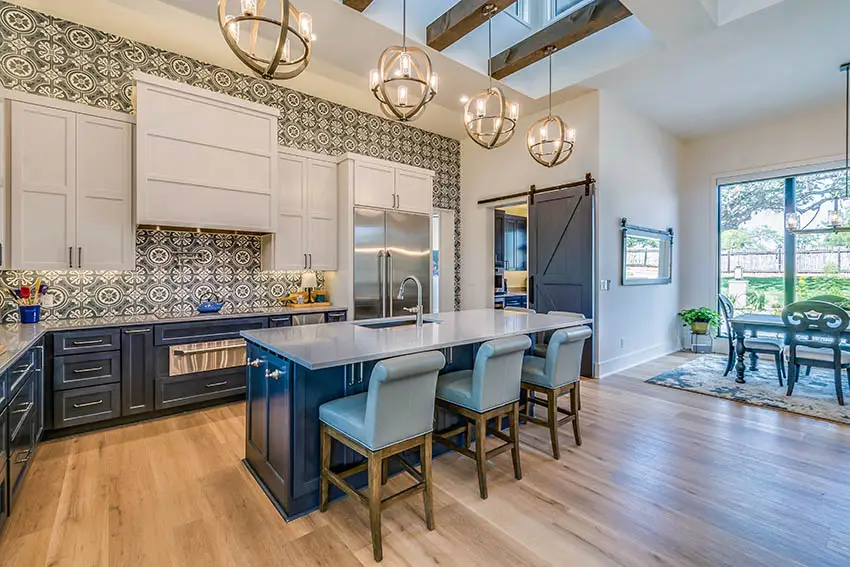 Contemporary kitchen with gray dekton countertops two tone cabinets white and blue island globe pendant lights
