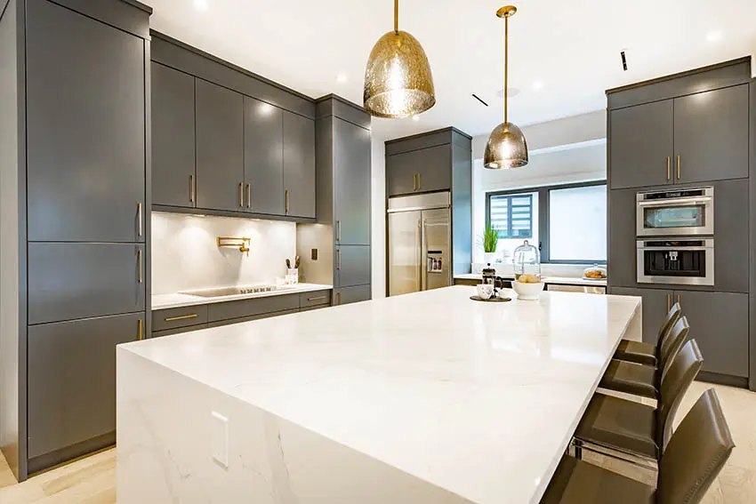 Contemporary kitchen with gray lacquer cabinets gold hardware white quartz countertops gold pendant lights