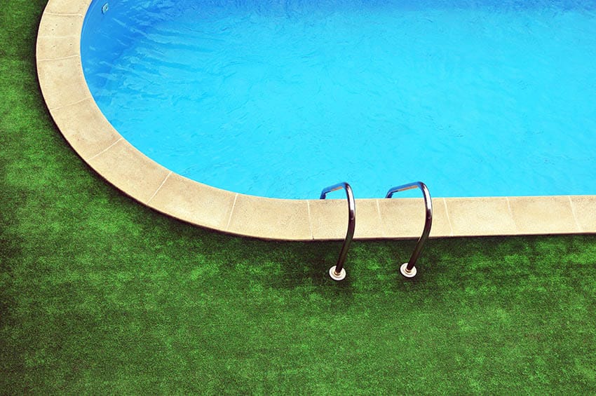 Fake grass surrounding an oval pool