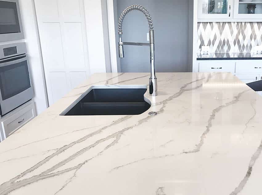 Kitchen island with silgranit sink callacatta quartz countertops