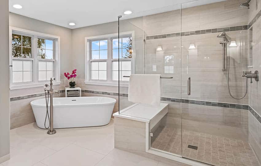 Master bathroom with white ceramic tile floors corner freestanding tub walk in shower