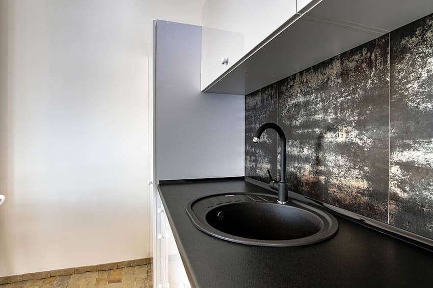 Modern kitchen with small round silgranit sink black pearl leathered granite countertops