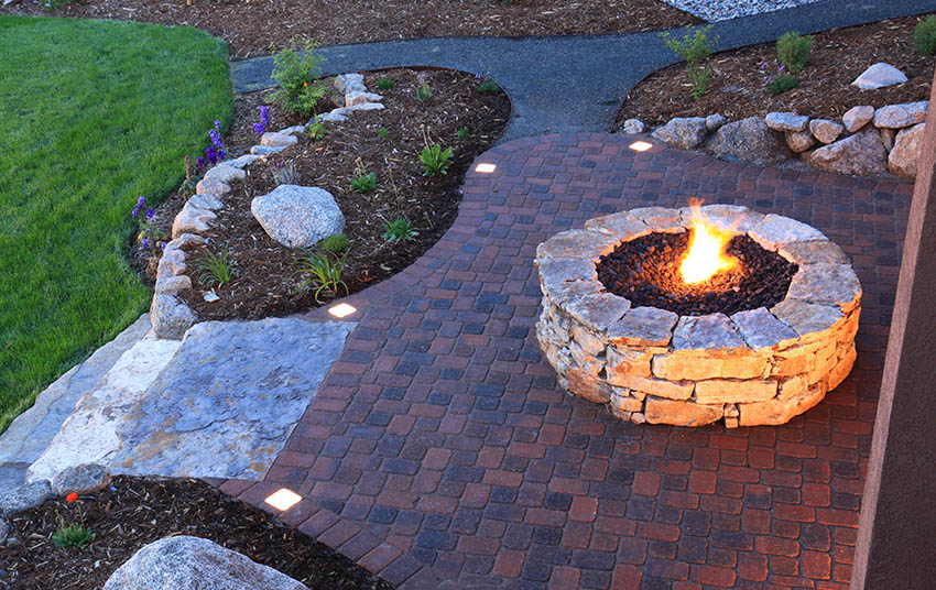 Patio with sealed brick pavers stone fire pit rock grass mulch landscaping