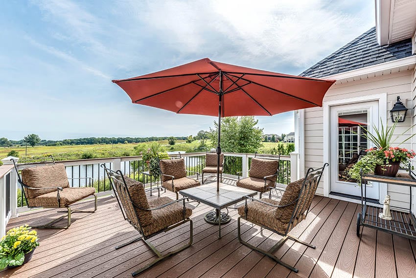 Raised azek deck with white railing outdoor dining waterfront views