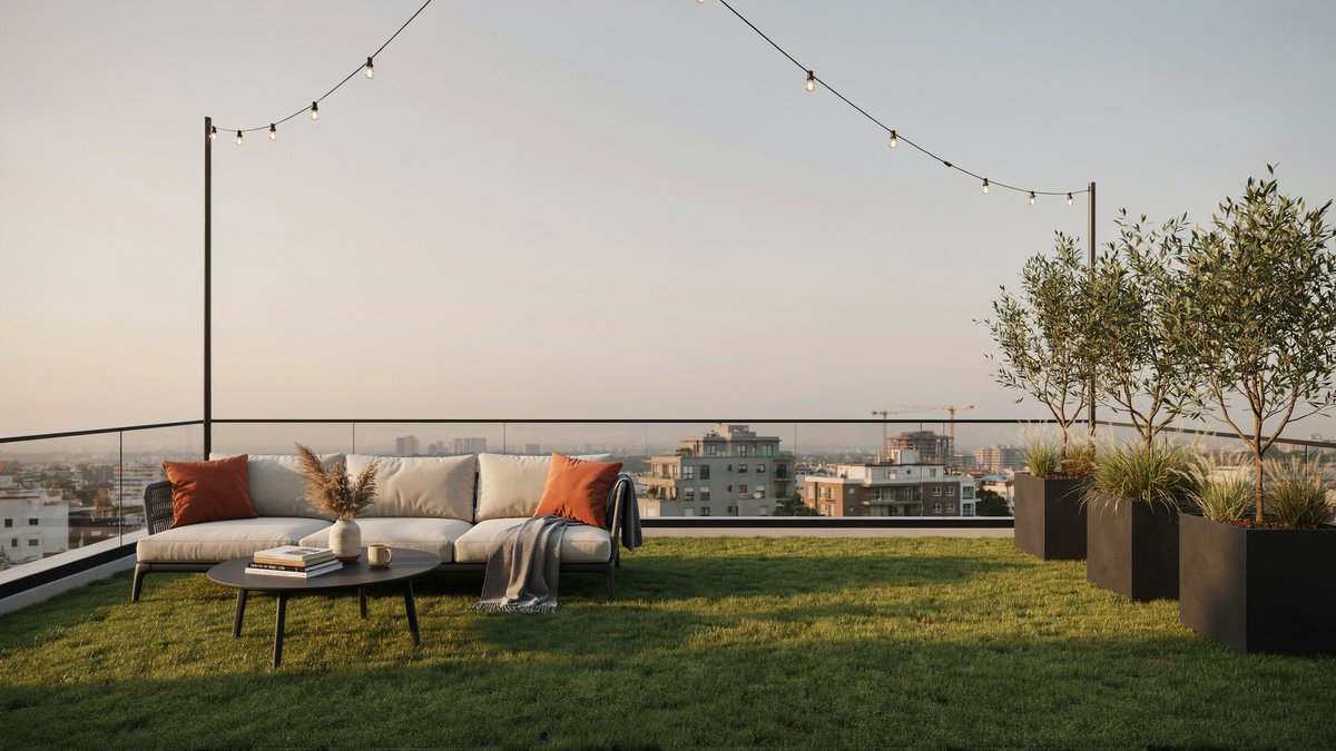 Rooftop turf lounge with sectional, planters and city skyline at dusk