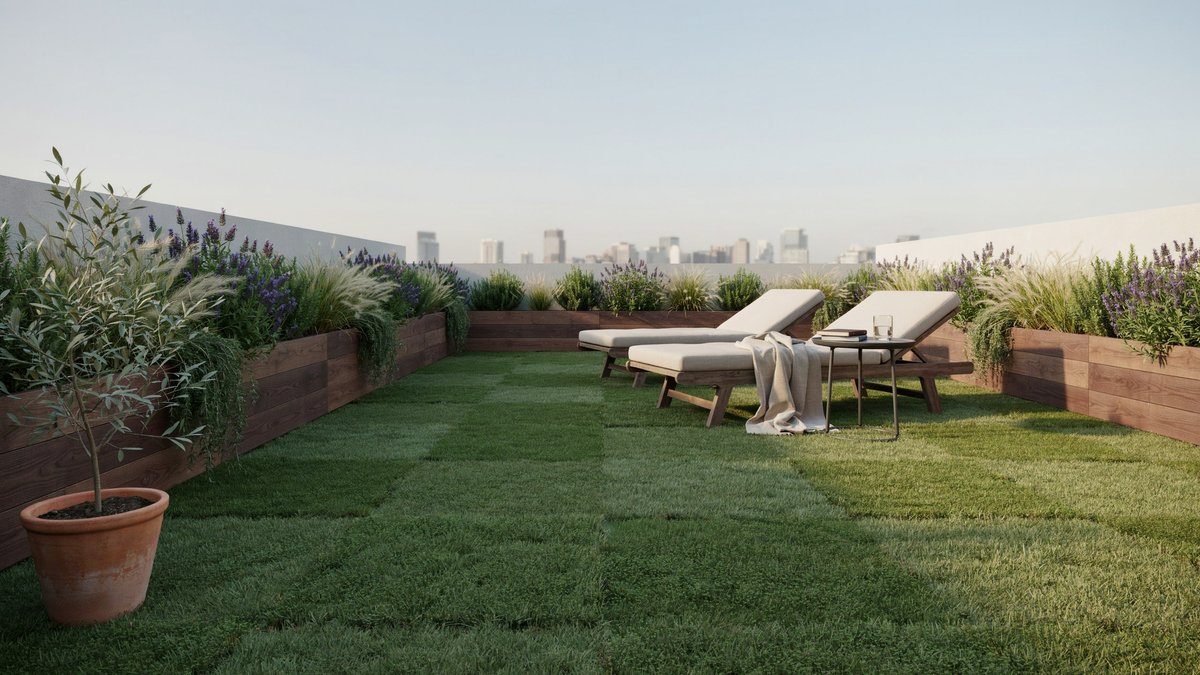 Two loungers on rooftop turf between raised wood planters and skyline