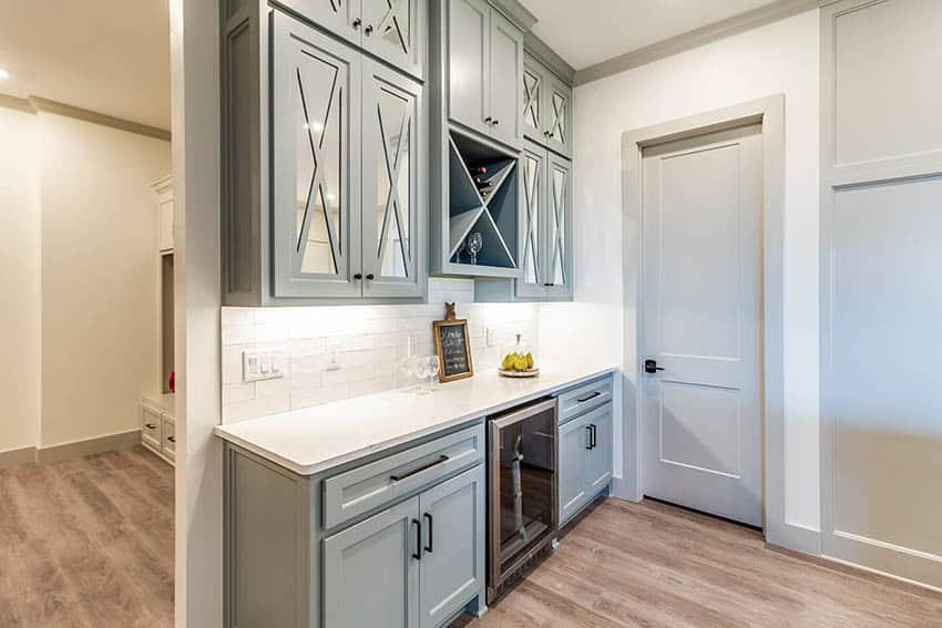 Stylish home bar with wine fridge light grey cabinets white solid surface countertops