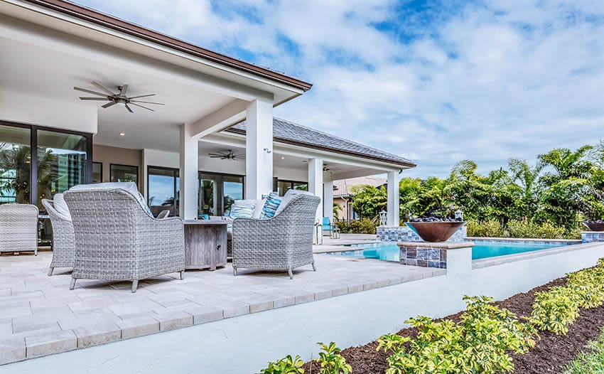 White pool deck pavers with raised patio