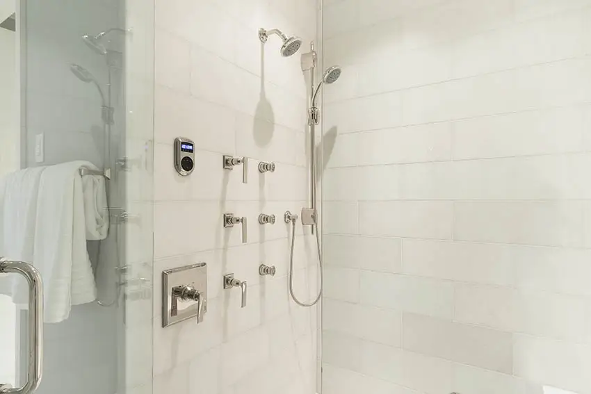 Shower wall with lots of knobs with handheld shower