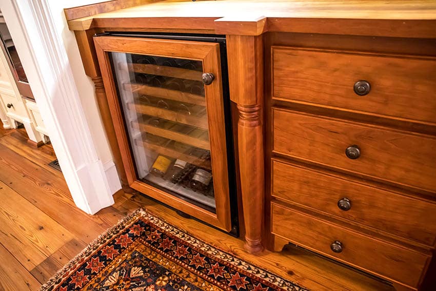 Wood home bar with wine bottle refrigerator