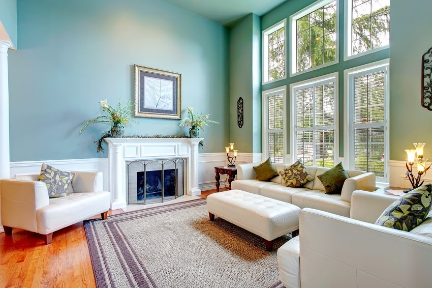 high ceiling aqua sunroom color with white leather couch ottaman armchairs and fireplace