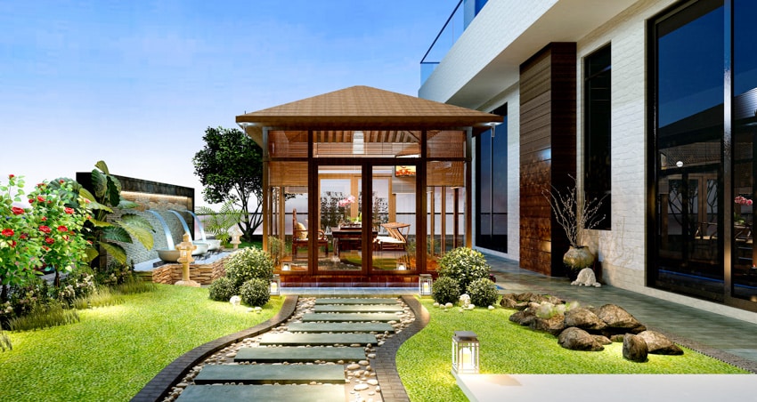 Backyard pathway illuminated by lighting system and modern pergola