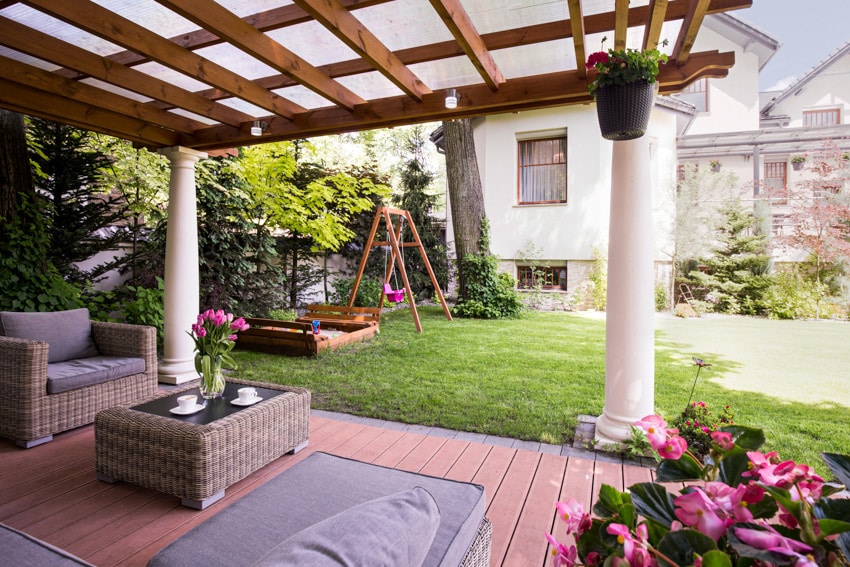 Backyard pergola with down light rattan furniture and greeneries