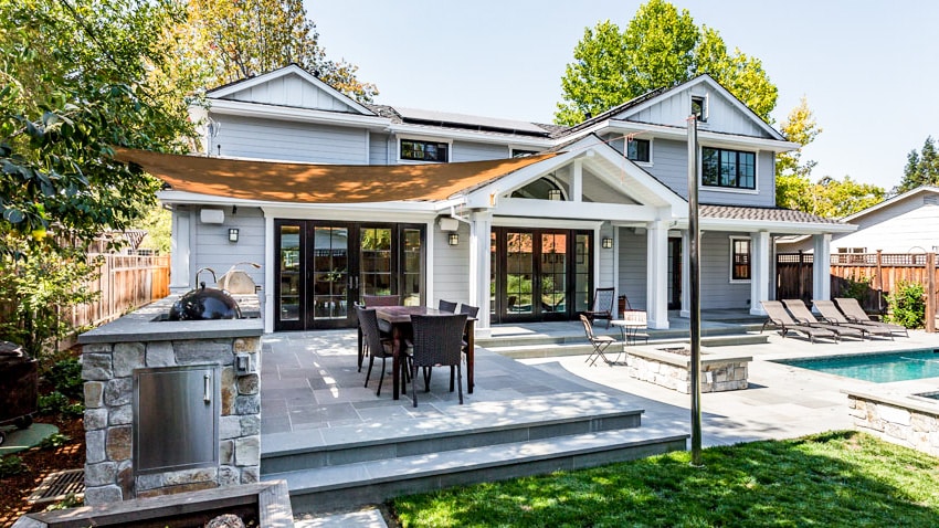 Backyard with outdoor kitchen canopy cover and patio folding door