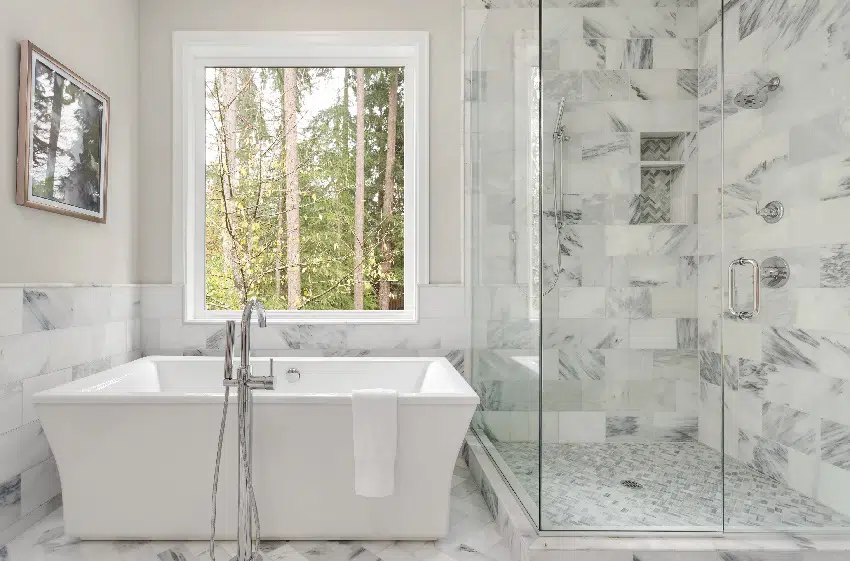 https://designingidea.com/wp-content/uploads/2021/07/bathroom-interior-with-large-shower-elegant-tile-and-soaking-bathtub-large-window-with-view-of-trees-is.jpg.webp