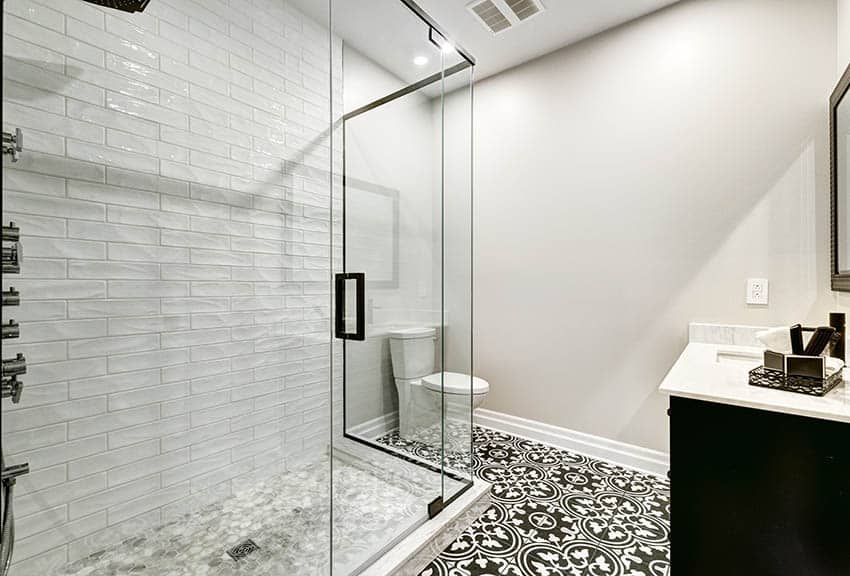 Bathroom shower with porcelain mosaic tile floor and black white spanish style tile floor