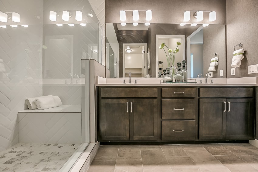 Bathroom with built in shower bench mirror and wood drawers