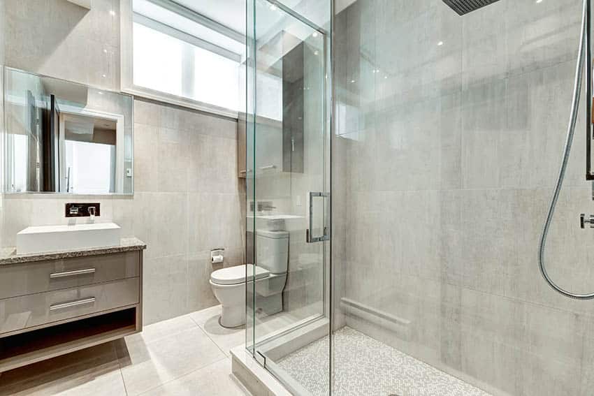 Bathroom with small glass mosaic tile shower floor floating vanity