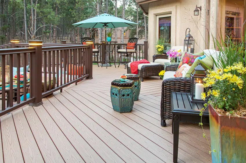 beautiful backyard composite decking with built in lighting and fully decorated vibrant colorful furniture and decor