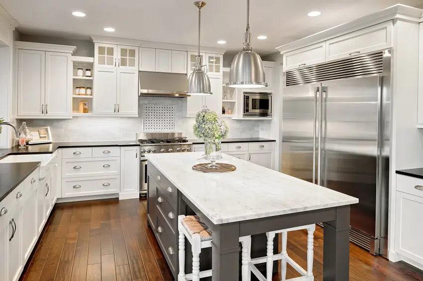 beautiful kitchen with white cabinets stainless steel fridge and stove