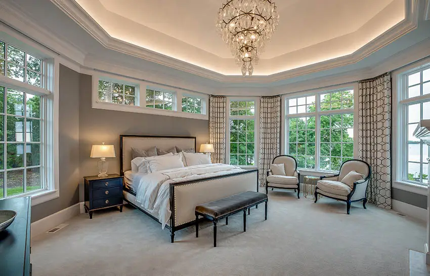 Beautiful bedroom with lighted geometric tray ceiling