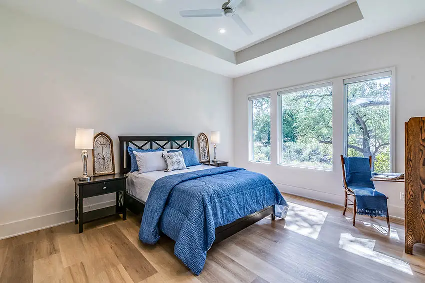Bedroom with simple tray ceiling and fan